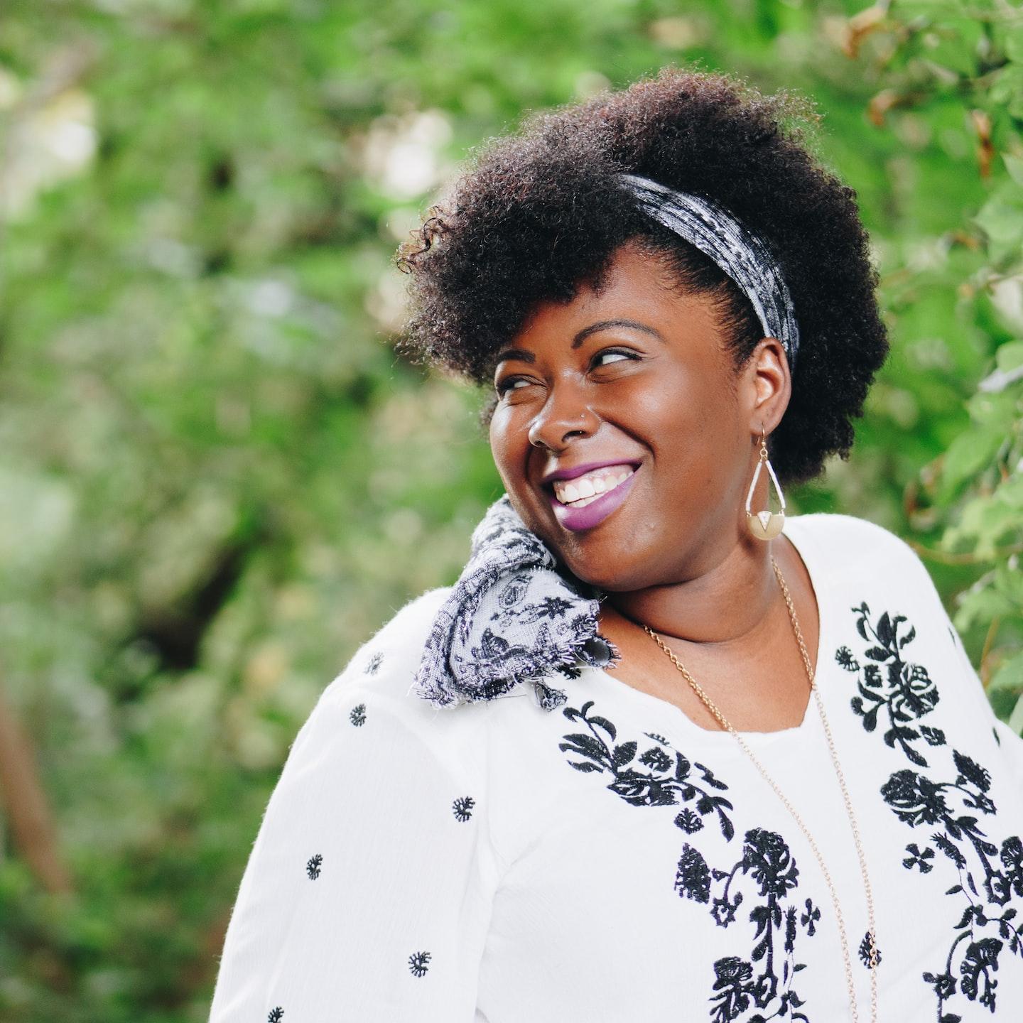 smiling woman looking on right side during daytime